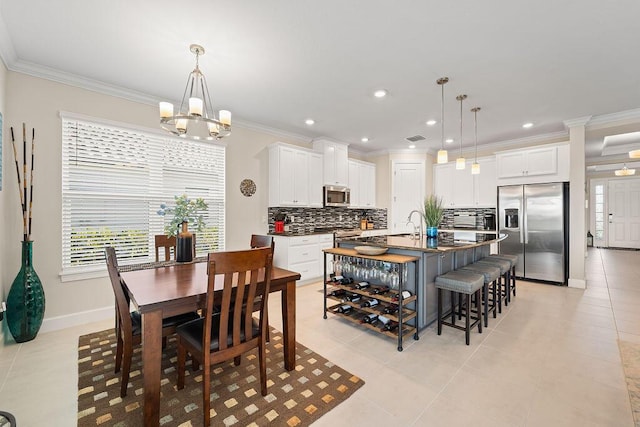 tiled dining area with an inviting chandelier, crown molding, and sink