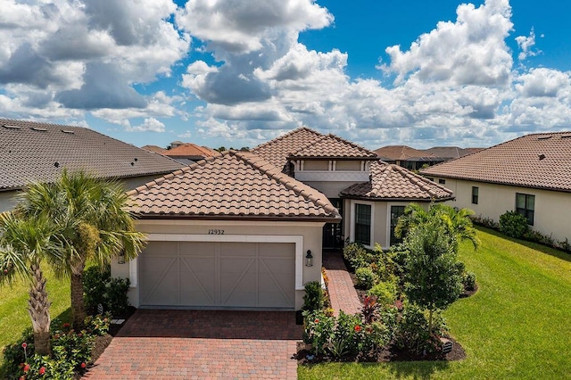 mediterranean / spanish house with a front yard and a garage