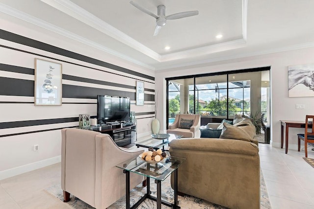 tiled living room with a raised ceiling, ceiling fan, and crown molding