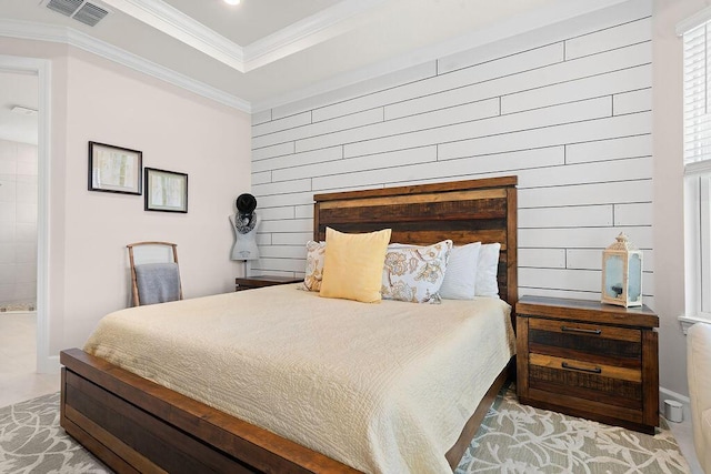 bedroom featuring ensuite bathroom and ornamental molding