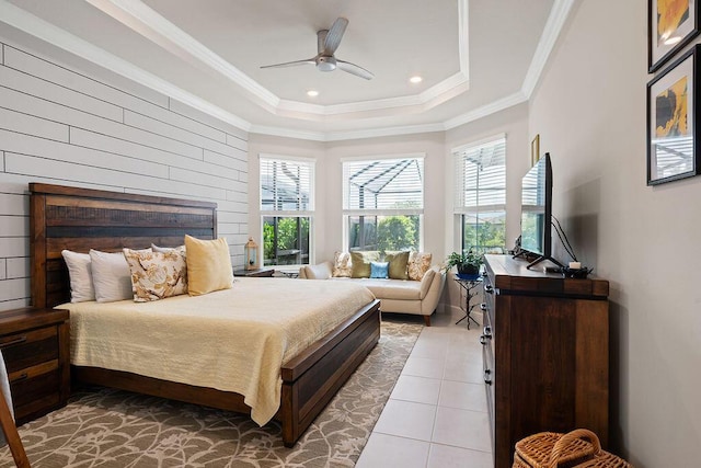 bedroom with a raised ceiling, ceiling fan, light tile patterned floors, and ornamental molding