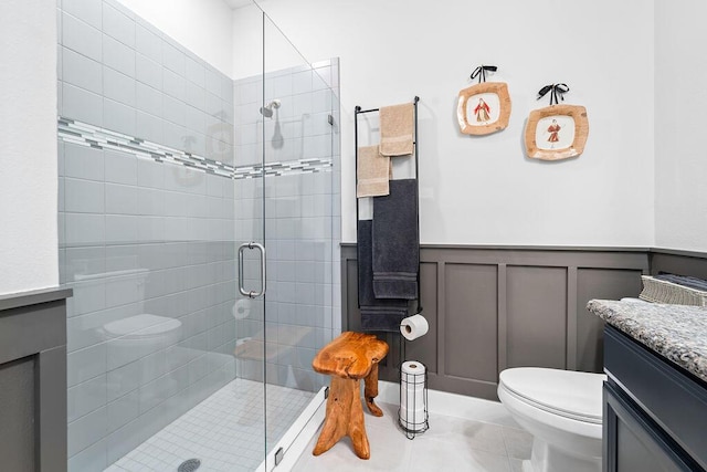 bathroom with tile patterned floors, vanity, toilet, and an enclosed shower