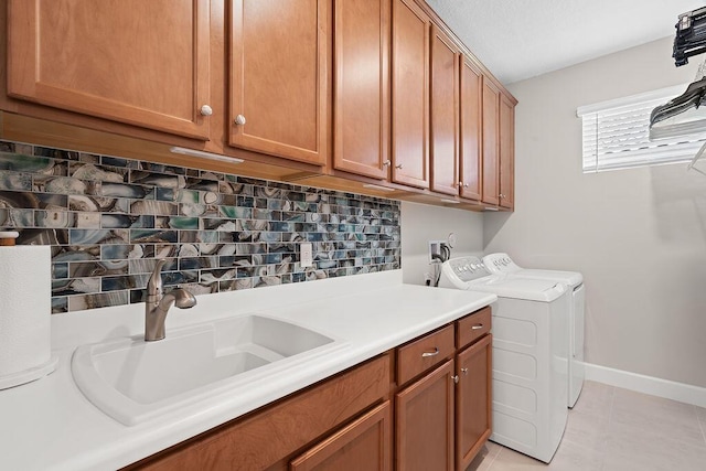 washroom featuring cabinets, independent washer and dryer, sink, and light tile patterned floors