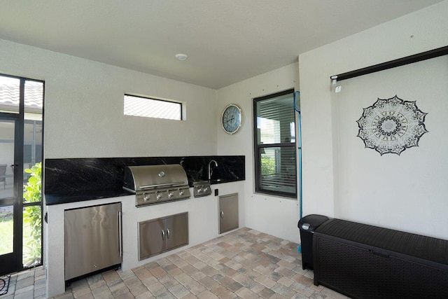 view of patio / terrace featuring sink, grilling area, and exterior kitchen