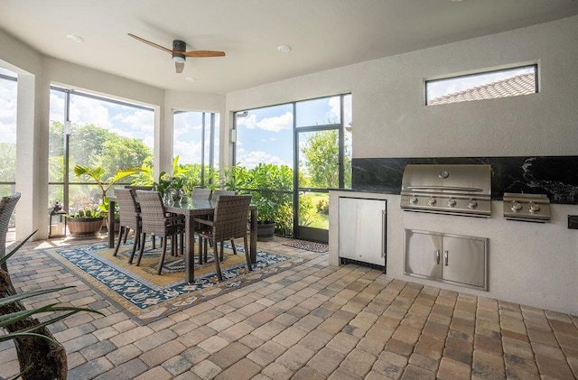 sunroom / solarium featuring ceiling fan