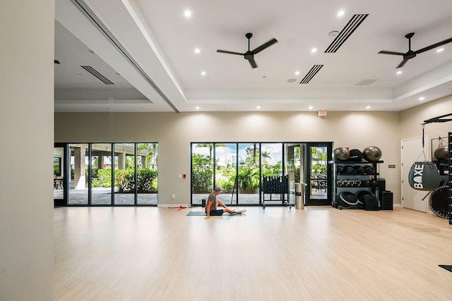 interior space featuring a tray ceiling, a wealth of natural light, and ceiling fan