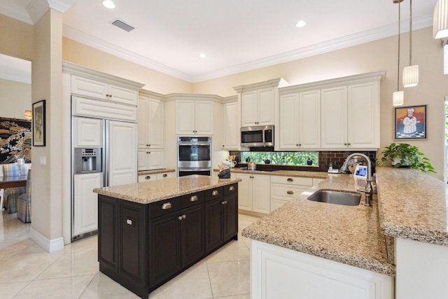 kitchen featuring sink, kitchen peninsula, pendant lighting, light tile patterned floors, and appliances with stainless steel finishes