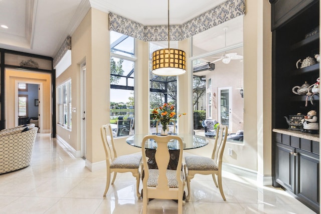 tiled dining space featuring crown molding and ceiling fan