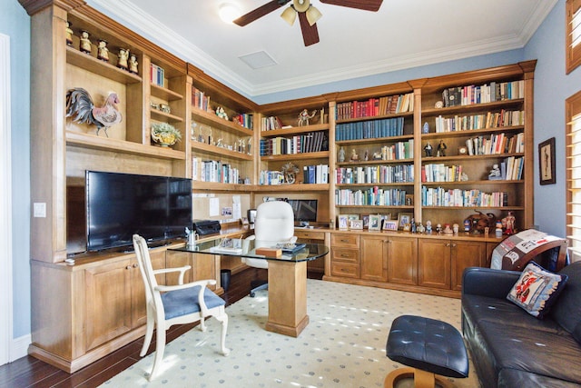 office area featuring built in desk, ceiling fan, and ornamental molding