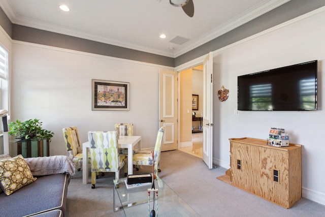 dining room featuring ceiling fan, ornamental molding, and light carpet