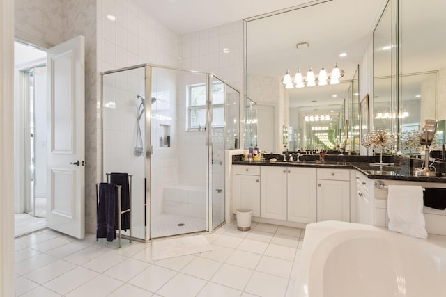 bathroom featuring tile patterned flooring, vanity, and separate shower and tub