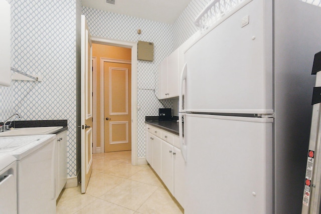 clothes washing area featuring light tile patterned floors, sink, and washer / clothes dryer