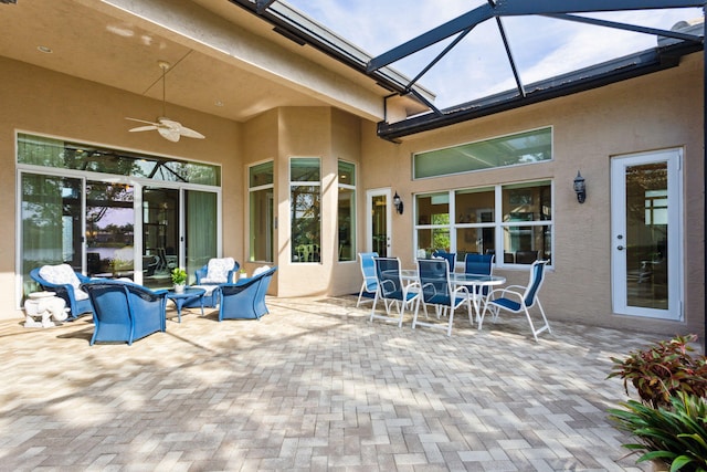 view of patio / terrace featuring glass enclosure and ceiling fan