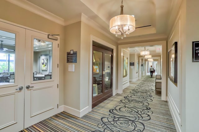 interior space featuring french doors, ornamental molding, and a notable chandelier