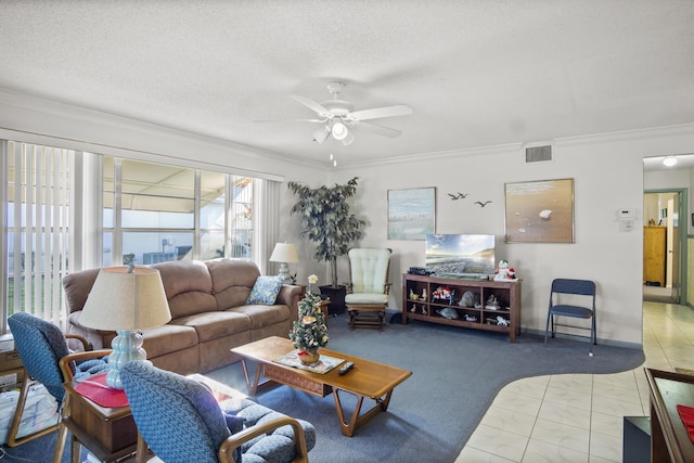 living room with ceiling fan, carpet floors, a textured ceiling, and ornamental molding