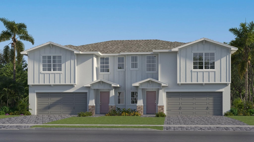 view of front of home featuring a garage and a front lawn