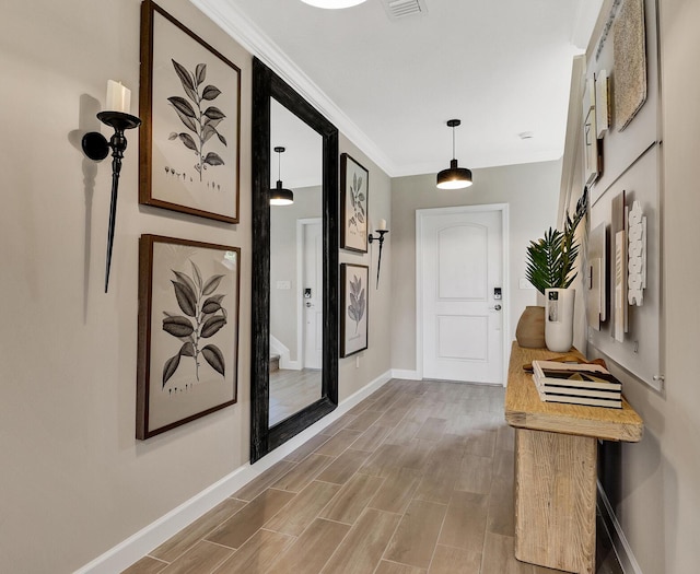 hall with ornamental molding and hardwood / wood-style flooring