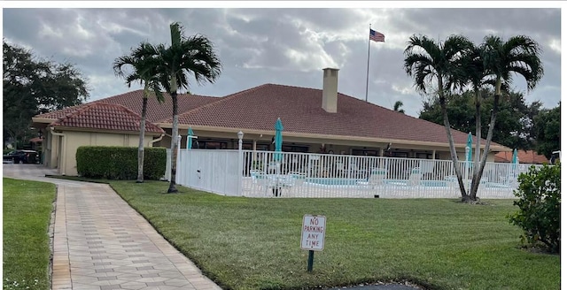 view of pool with a lawn