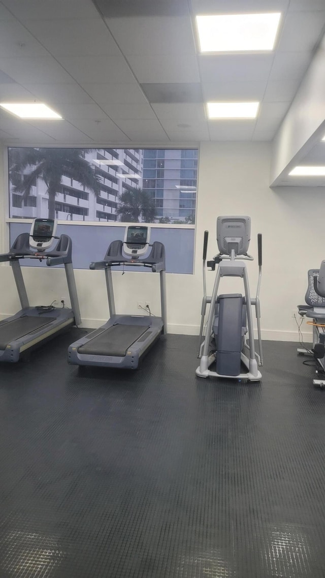 gym with a paneled ceiling