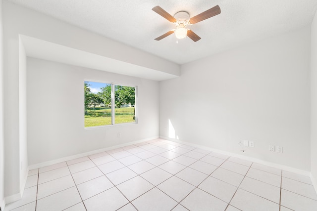 tiled empty room featuring ceiling fan