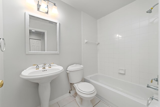 bathroom featuring tile patterned floors, toilet, and tiled shower / bath