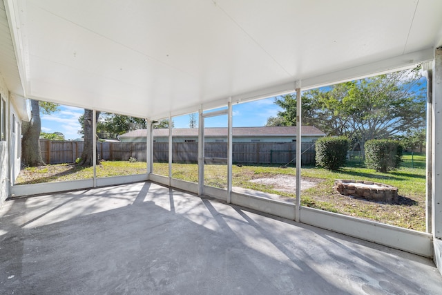 unfurnished sunroom with plenty of natural light and vaulted ceiling