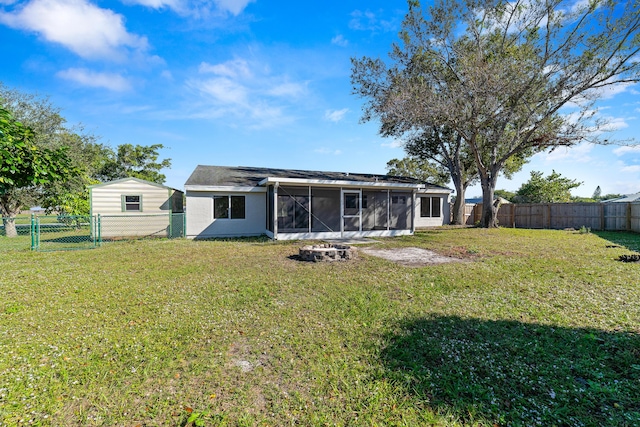 back of house with a lawn and a sunroom