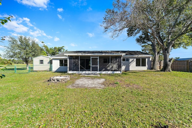 back of property featuring a yard and a sunroom