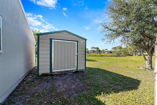 view of outbuilding featuring a yard