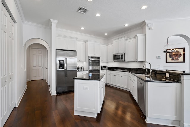 kitchen with white cabinetry, sink, a center island, and appliances with stainless steel finishes