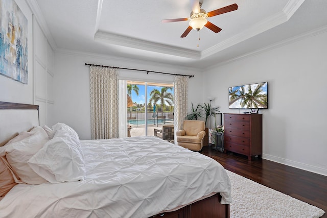 bedroom featuring ornamental molding, access to outside, ceiling fan, and a tray ceiling