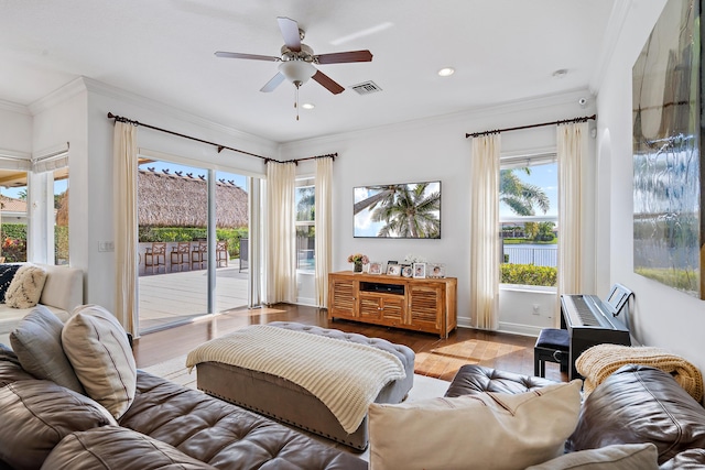 living room with ornamental molding, a healthy amount of sunlight, ceiling fan, and light hardwood / wood-style floors