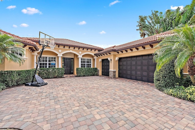 mediterranean / spanish house with a garage