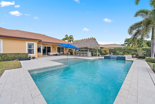 view of swimming pool with a patio and exterior bar