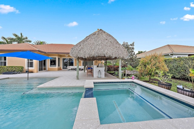 view of swimming pool featuring a gazebo, exterior bar, and a patio