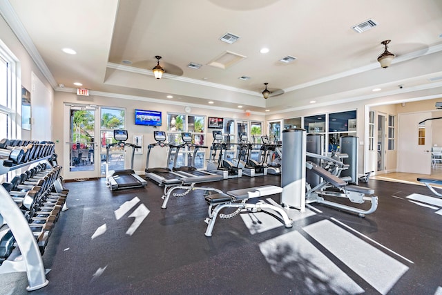 gym with ornamental molding, a raised ceiling, ceiling fan, and french doors