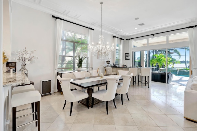 tiled dining room featuring crown molding, plenty of natural light, and an inviting chandelier