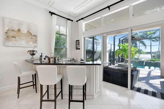 bar with white cabinetry and light tile patterned floors