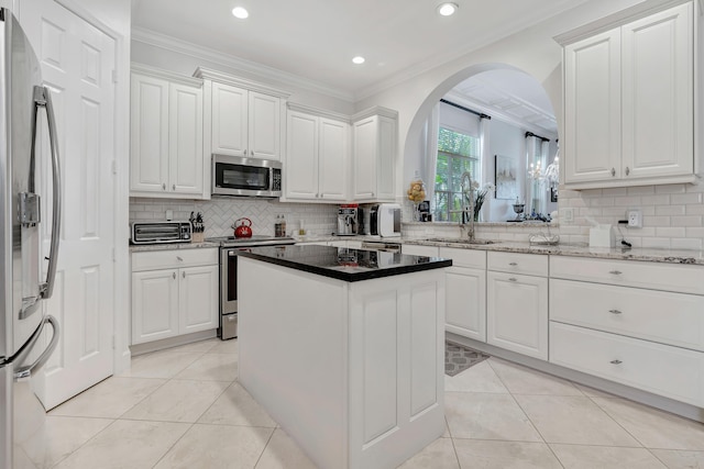 kitchen with white cabinetry, sink, crown molding, and appliances with stainless steel finishes