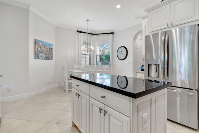 kitchen with white cabinetry, a center island, light tile patterned floors, and stainless steel refrigerator with ice dispenser