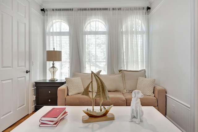 living area featuring plenty of natural light and ornamental molding