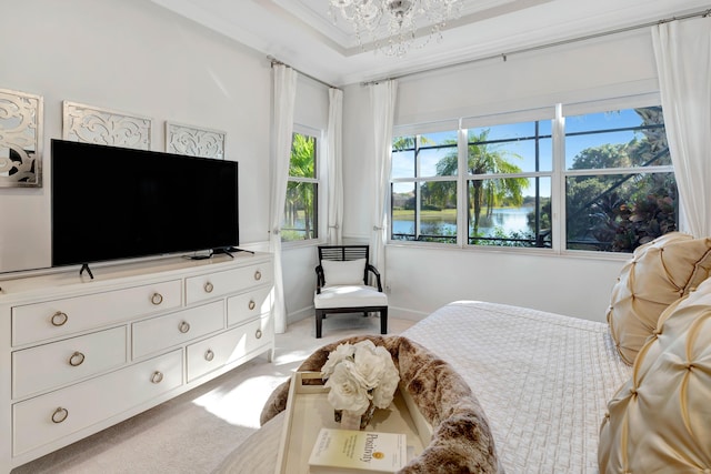 carpeted bedroom featuring crown molding and a chandelier