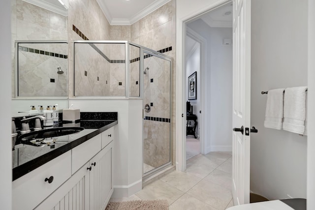 bathroom with vanity, a shower with shower door, and crown molding