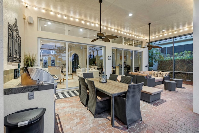 view of patio / terrace featuring an outdoor kitchen, an outdoor hangout area, and ceiling fan