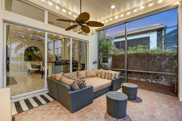 sunroom / solarium featuring ceiling fan