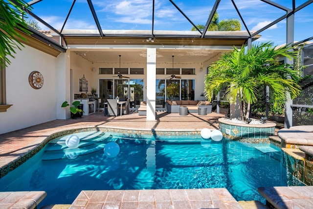 view of pool featuring outdoor lounge area, glass enclosure, ceiling fan, area for grilling, and a patio