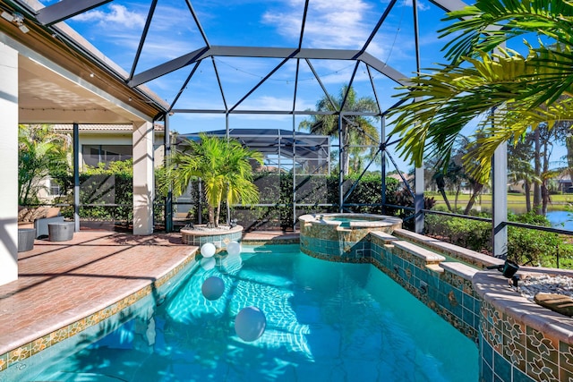 view of pool with a lanai, an in ground hot tub, and a patio