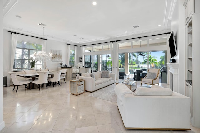 living room featuring french doors, ornamental molding, built in shelves, light tile patterned floors, and a chandelier