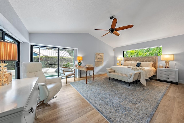 bedroom featuring a textured ceiling, light hardwood / wood-style floors, ceiling fan, and lofted ceiling