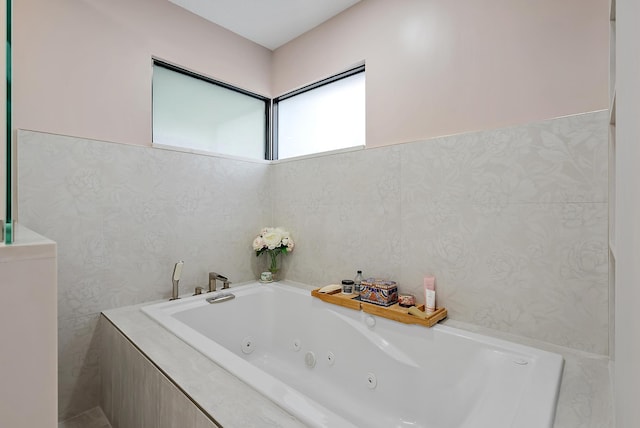 bathroom with a relaxing tiled tub